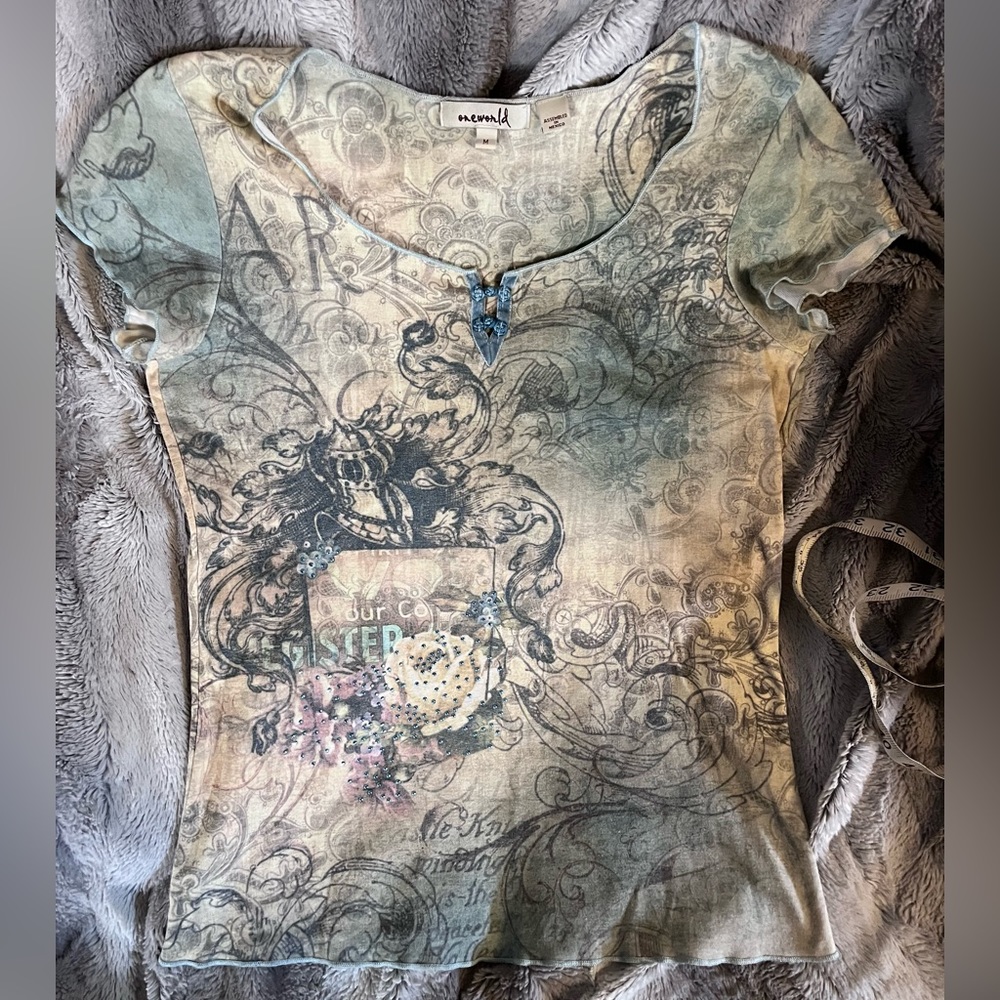 One World graphic tee with teal detail size M runs small. Armpit to armpit = 34”